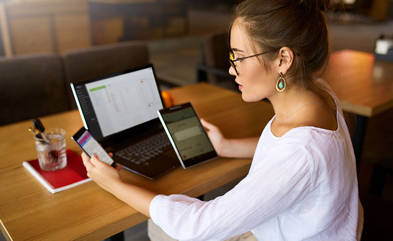 Woman using QPass in lapton, tablet and smartphone